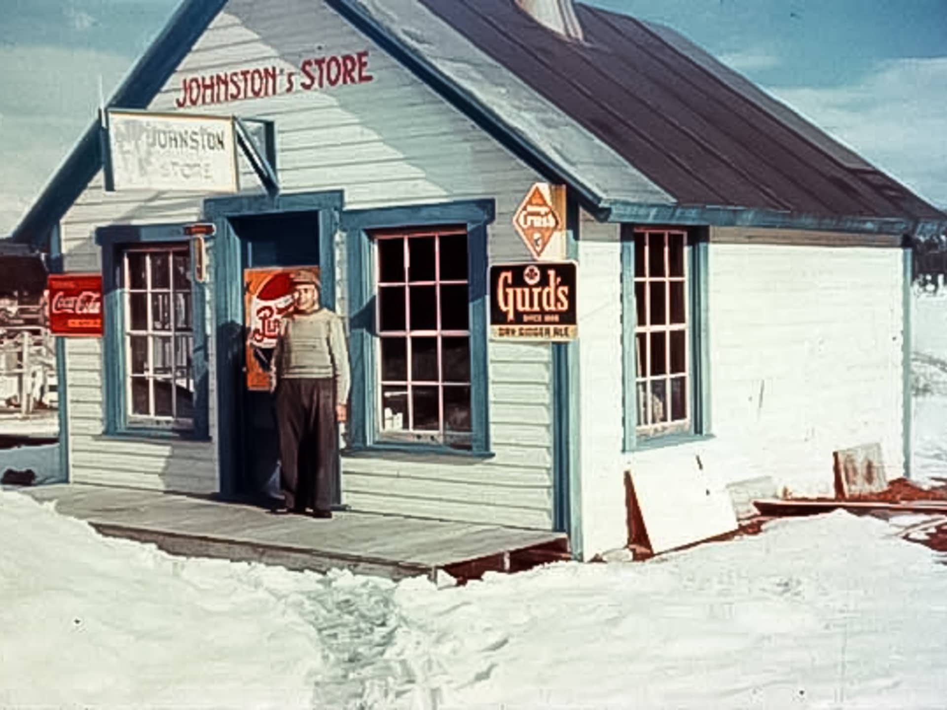 George Johnston standing in front of his Teslin store