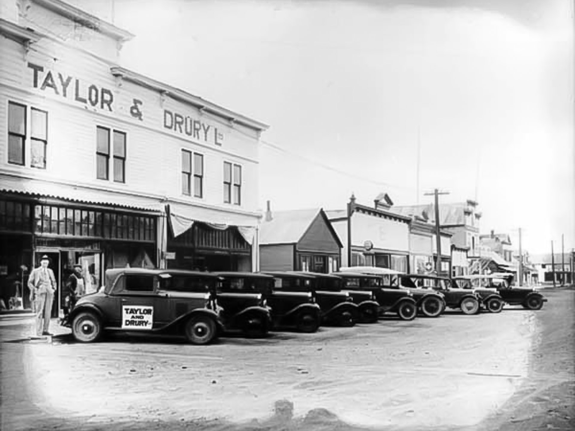 Cars for sale outside Taylor and Drury Store in Whitehorse 1928